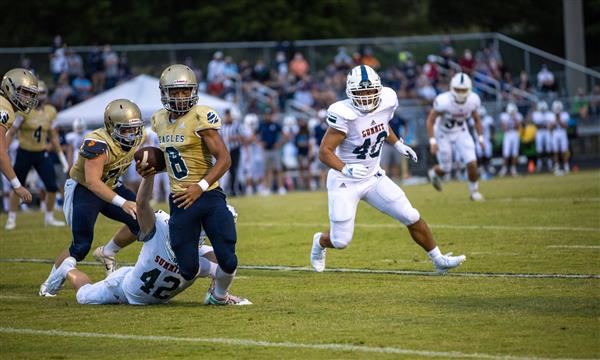 Summit High football player attempts to tackle Independence High player
